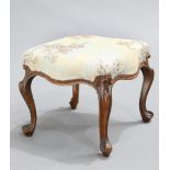 A VICTORIAN WALNUT STOOL, the upholstered seat raised on cabriole lets. 41cm wide