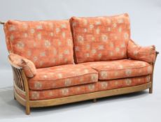 AN ERCOL "RENAISSANCE" GOLDEN DAWN THREE PIECE LOUNGE SUITE, comprising a three-seater sofa and a