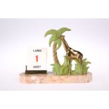 A FRENCH ART DECO 'GIRAFFE' CALENDAR, the marble base with rounded ends, supporting the spelter