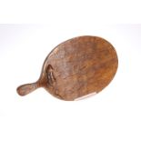 ROBERT THOMPSON OF KILBURN AN EARLY MOUSEMAN OAK CHEESEBOARD, carved mouse signature to the oval