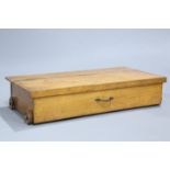 AN ARTS AND CRAFTS OAK UNDER-BED STORAGE OR BLANKET BOX, rectangular, with iron carrying handle