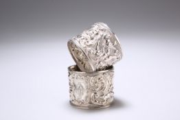 A PAIR OF EDWARDIAN SILVER NAPKIN RINGS, by Crisford & Norris, Birmingham 1902 and 1904, chased with