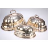 ^ A GRADUATED SET OF THREE SILVER-PLATED MEAT COVERS, of lobed circular form. Largest 43.5cm wide