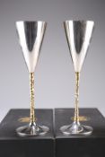 A PAIR OF STUART DEVLIN SILVER CHAMPAGNE FLUTES, London 1980, the flared flute with silver gilt bark