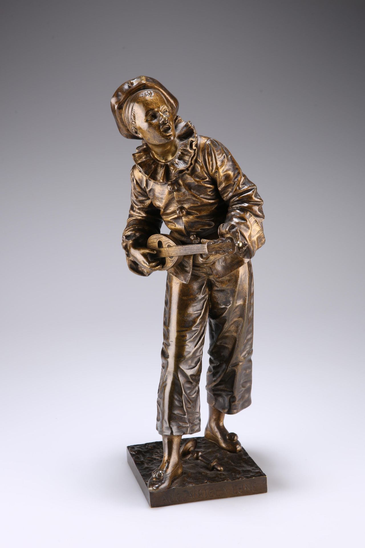 EUTROPE BOURET, "AU CLAIR DE LA LUNE", a patinated bronze of Pierrot playing the mandolin, on a