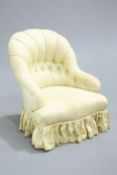 ~ A VICTORIAN BUTTON BACK ARMCHAIR, raised on turned legs.