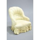 ~ A VICTORIAN BUTTON BACK ARMCHAIR, raised on turned legs.