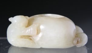 A CHINESE JADE BRUSH WASH, carved with a child and cat either side of the vessel. 2cm by 6cm.