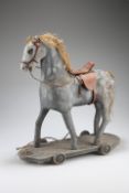A VICTORIAN PAINTED PAPIER MACHE PULL ALONG HORSE, with leather saddle and bridle. 44cm highThe