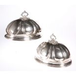 A PAIR OF 19TH CENTURY SILVER-PLATED MEAT COVERS, each engraved with a crest and the motto '