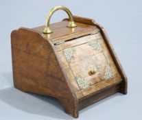 A VICTORIAN BRASS MOUNTED OAK SLANT FRONT COAL BOX, with tin liner and shovel. 40cm high