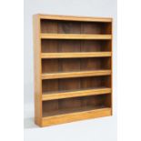 ARTHUR SIMPSON OF KENDAL AN ARTS AND CRAFTS OAK OPEN BOOKCASE, the shelves with hinged flaps,