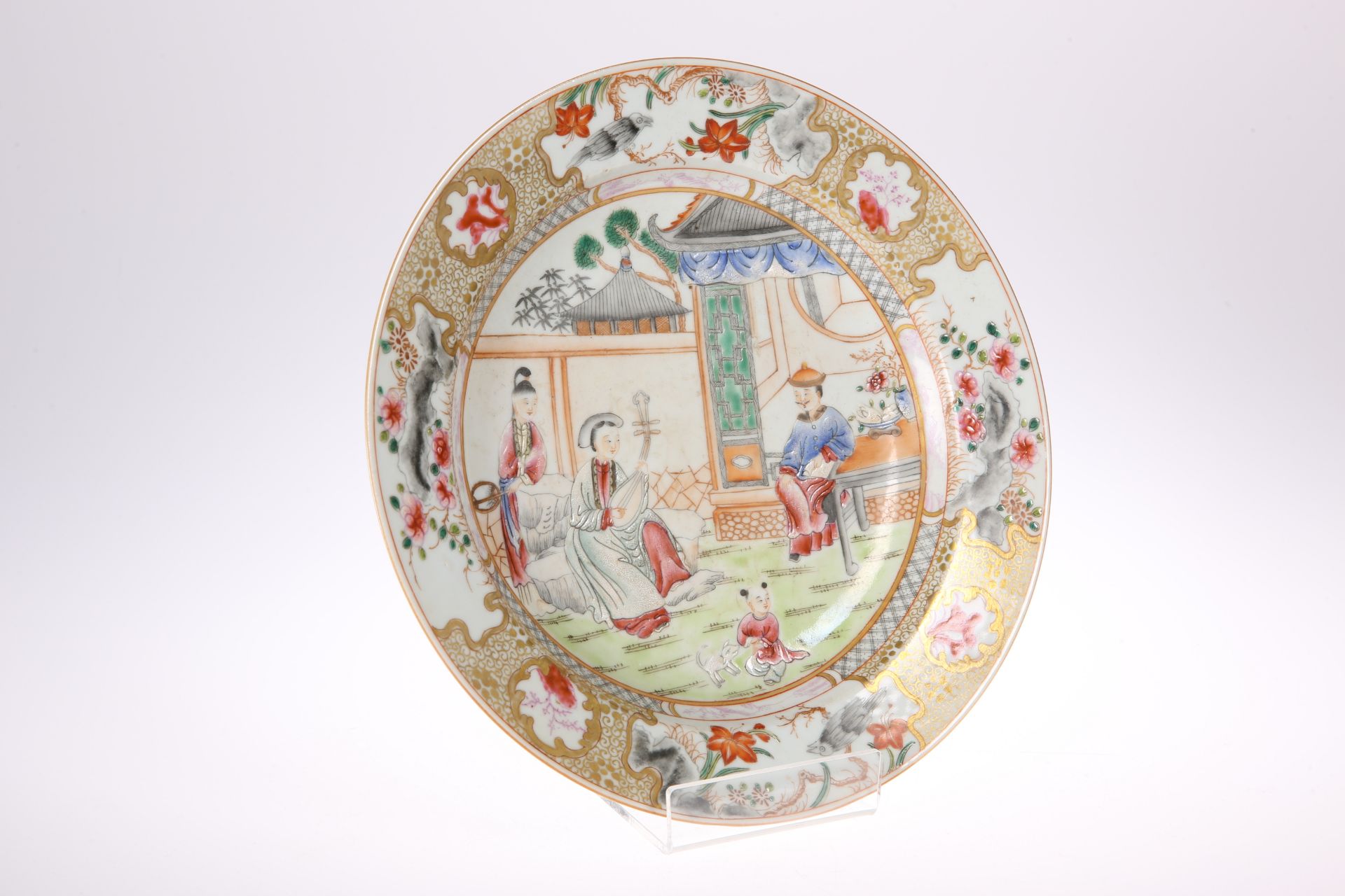 A CHINESE FAMILLE ROSE DISH, circular, enamel painted with a family in a garden, within a border