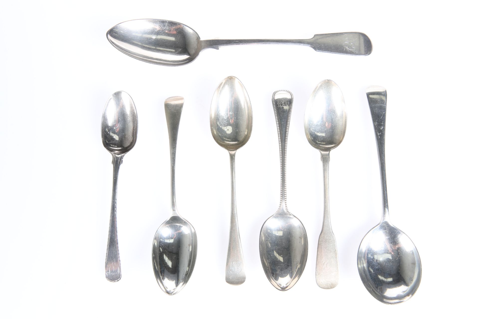 SEVEN ASSORTED GEORGIAN AND VICTORIAN SILVER SPOONS, comprising four dessert spoons of typical form,