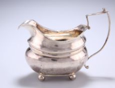 A GEORGE III SILVER CREAM JUG, by Alexander Field, London 1817, Duty Mark, squat ribbed design