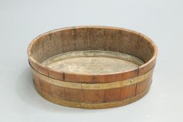 A 19TH CENTURY BRASS-BOUND COOPERED TEAK JARDINIERE, oval, tin tray to base. 74cm long, 57cm wide