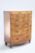 ~ A LARGE 19TH CENTURY INLAID MAHOGANY CHEST OF DRAWERS, bow fronted, the top with reeded edge