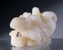 A CHINESE JADE CARVING, DEPICTING A RAT WITH YOUNG ATOP A PILE OF COINS. 4.5cm by 8cm.