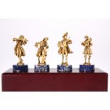 A CASED SET OF FOUR SILVER GILT MUSICIANS, by C.S.R Ltd, Import London 1976, each modelled playing