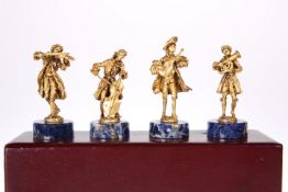 A CASED SET OF FOUR SILVER GILT MUSICIANS, by C.S.R Ltd, Import London 1976, each modelled playing