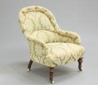 A VICTORIAN MAHOGANY AND UPHOLSTERED ARMCHAIR, with button-back and arms, raised on turned legs with