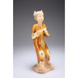 A CHINESE TANG STYLE FIGURE OF A MUSICIAN, modelled holding an instrument, ochre glazed with