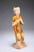 A CHINESE TANG STYLE FIGURE OF A MUSICIAN, modelled holding an instrument, ochre glazed with