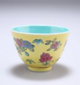 A CHINESE YELLOW GROUND CUP, polychrome enamel painted with scattered flowers, the interior with