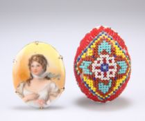 A PRISONER OF WAR BEADWORK EGG, together with A BRASS-MOUNTED PORCELAIN BROOCH, oval, printed with