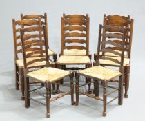 A MATCHED SET OF EIGHT LANCASHIRE ELM AND OAK RUSH-SEATED LADDER BACK DINING CHAIRS, each with