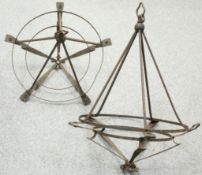 A PAIR OF WROUGHT IRON HANGING CEILING LIGHTS, CIRCA 1900, circular with whiplash shaped supports.