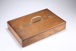AN EDWARDIAN OAK CUTLERY TRAY, with twin flaps and polished metal handle. 40cm long