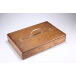 AN EDWARDIAN OAK CUTLERY TRAY, with twin flaps and polished metal handle. 40cm long