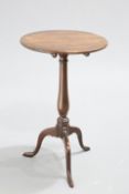 A GEORGE III MAHOGANY TILT-TOP TRIPOD TABLE, the circular top raised on a slender baluster stem