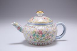 A CHINESE FAMILLE ROSE TEAPOT, of squat form, densely enamel painted with foliage, bears