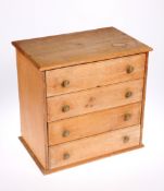 ~ A VICTORIAN PINE MINIATURE CHEST OF DRAWERS, with four drawers and brass pulls. 35cm high, 36.