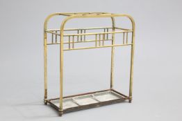 AN EDWARDIAN BRASS STICKSTAND, with drip tray. 55cm wide