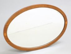 AN EDWARDIAN INLAID MAHOGANY OVAL MIRROR, inlaid with paterae. 83cm by 57cm