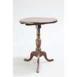 AN EARLY 19TH CENTURY MAHOGANY TILT-TOP TRIPOD TABLE, the circular top raised on a baluster stem