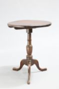 AN EARLY 19TH CENTURY MAHOGANY TILT-TOP TRIPOD TABLE, the circular top raised on a baluster stem