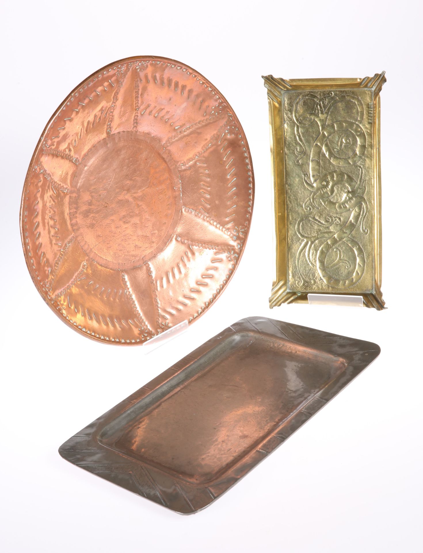 A KESWICK BRASS TRAY, rectangular with everted corners and gallery edge, repousse with a scrolling