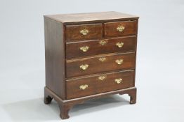 A GEORGE III OAK CHEST OF DRAWERS, the moulded rectangular top over two short over three long
