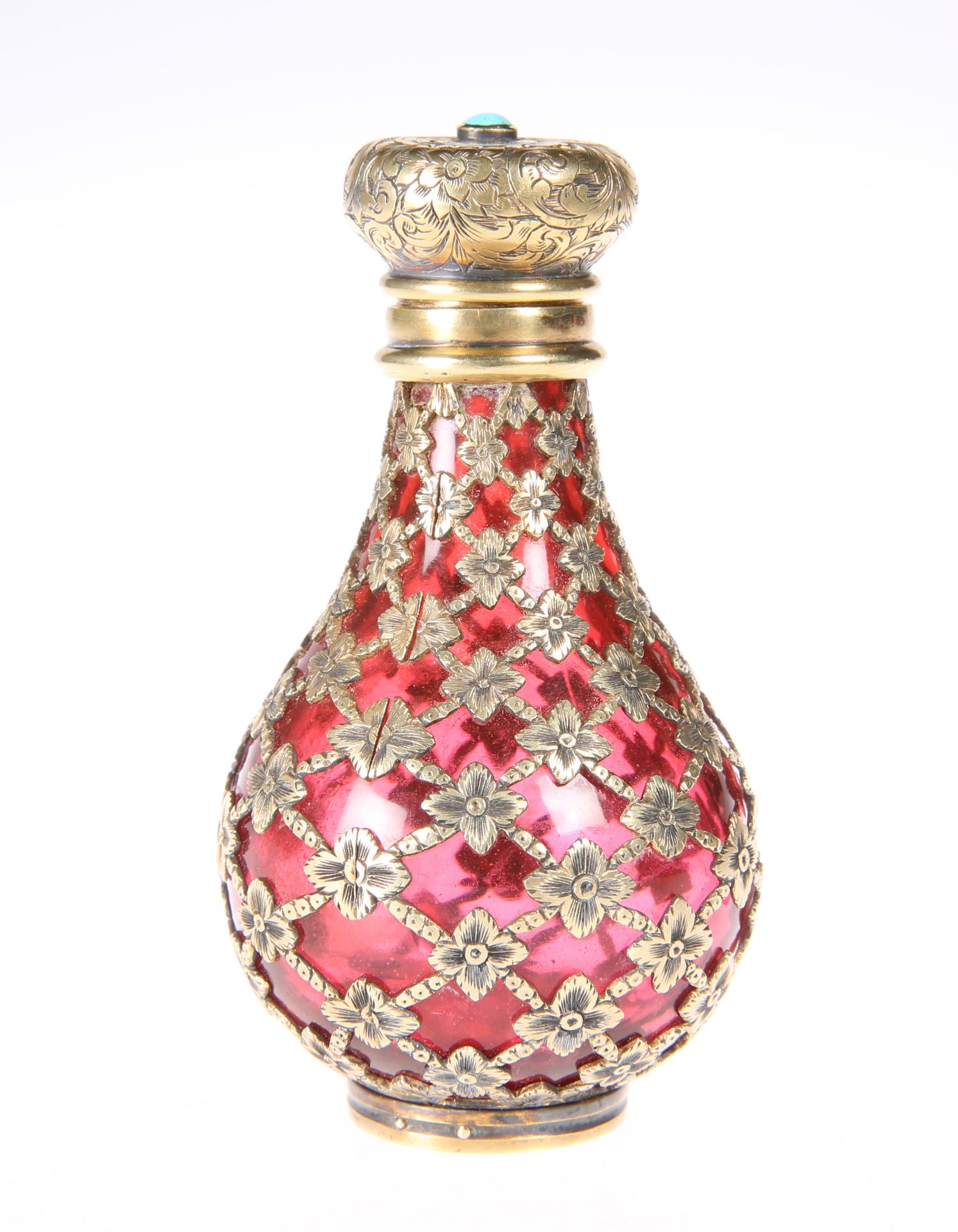 A VICTORIAN GILT-METAL MOUNTED CRANBERRY GLASS SCENT BOTTLE, the lattice overlay with flowerheads,
