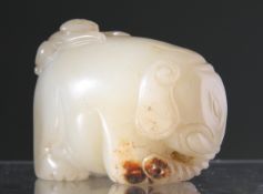 A CHINESE JADE CARVING, depicting an elephant with a monkey clinging to its back. 4cm by 6cm.