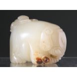 A CHINESE JADE CARVING, depicting an elephant with a monkey clinging to its back. 4cm by 6cm.