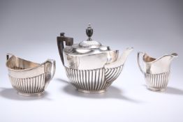 AN EDWARD VII SILVER THREE PIECE TEA SET, by William Hutton & Sons, London 1908, oval form with half