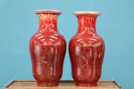 A LARGE PAIR OF CHINESE SANG DE BOEUF VASES, of substantial baluster form with tall neck and everted