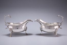 A PAIR OF GEORGE III SILVER SAUCE BOATS, probably Walter Brind, London 1767 AND 1771, with gadroon