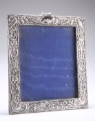 AN EDWARDIAN SILVER-FRONTED PHOTOGRAPH FRAME, by Henry Matthews, Birmingham 1907, cast with birds