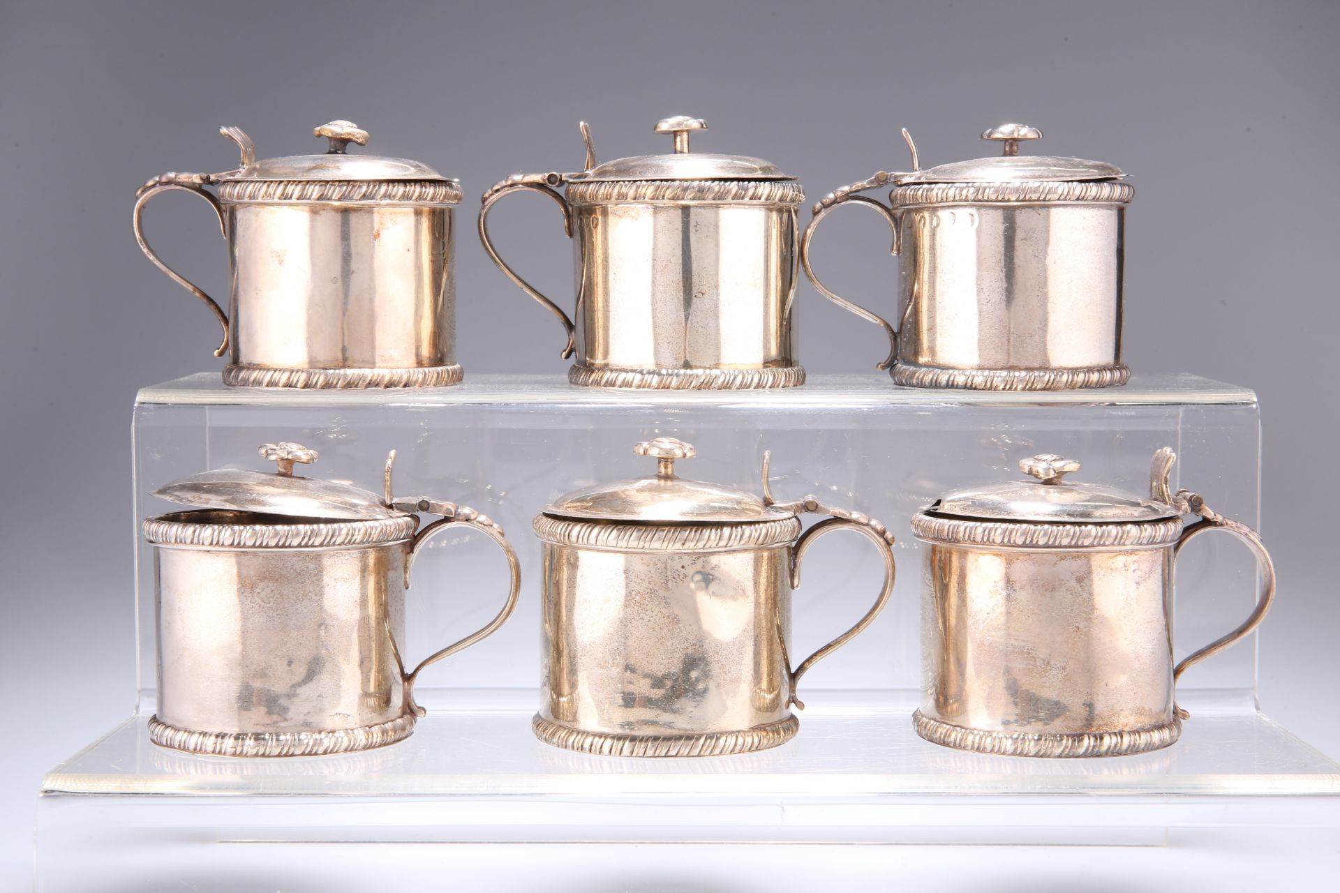 ^ A COLLECTION OF SIX SILVER DRUM MUSTARDS, comprising a pair by John Bodman Carrington, London